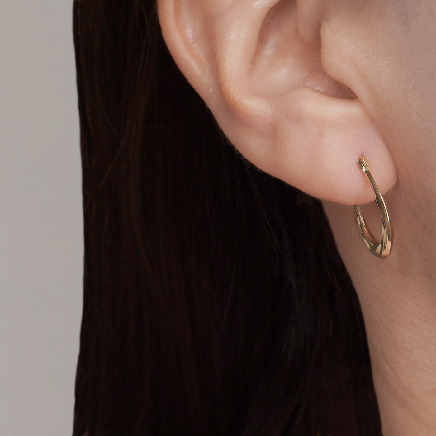 Solid Gold Twist Design Oval Shape Hoop Earrings